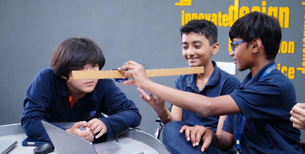 At Prometheus School, secondary students are collaborating on their robotics project work, demonstrating their dedication to teamwork and hands-on learning